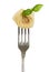 Tortellini with basil leaf on a fork