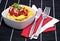 Tortellini in a bowl on black background