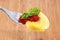 Tortellini on a fork with wooden background