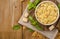 Tortellini mignon on a wooden board with basil and parmesan. Specialties of the cuisine from Bologna and Emilia Romagna