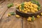 Tortellini mignon on a wooden board with basil and parmesan. Specialties of the cuisine from Bologna and Emilia Romagna