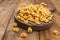 Tortellini mignon on a wooden board l and parmesan. Specialties of the cuisine from Bologna and Emilia Romagna