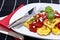 Tortellini on a plate against black background