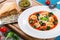 Tortellini soup with italian sausages, spinach, tomato, parmesan cheese , pesto-sauce