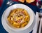 Tortiglioni in carbonara cheese sauce with cured meat guanciale