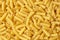 Tortiglioni italian pasta is short pasta with ribbed surface and straight cut, similar to small tubes
