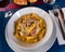 Tortiglioni pasta carbonara with cheese sauce and cured pork