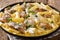 Tortiglioni with pieces of chicken in a creamy cheese sauce with herbs close-up in a plate. horizontal