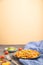 Tortiglioni semolina pasta with tomato and microgreen sprouts on a black and orange background. Side view, copy space