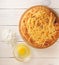 tortilla bread with cheese, raw egg and flour on wooden background