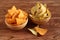 Tortilla chips nachosâ€™ Mexican and tortilla chips with chia seeds in bamboo bowls on wooden table.