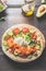 Tortilla with salmon,avocado, cheese, arugula, tomatoes and cucumbers. Flat bread with ingredients on a wooden table. Tortilla