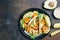 Tortilla tacos with arugula, lemon, avocado and grilled shrimp pawns