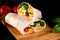 Tortilla wrapped with fried chicken meat, vegetables and corn