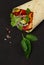 Tortilla wraps, grilled Mexican chicken with vegetables, burritos, on a black table, without people,