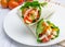 Tortilla wraps with roasted chicken fillet, fresh vegetables and sauce