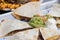 Tortillas with roasted meat garnished with sliced veggies and guacamole