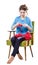 Tortured young girl in a sweater sits on a chair with a red ball of yarn and knitting a scarf and Spitz. Tired. White background.