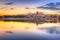 Torun old town reflected in Vistula river at sunset