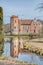 Torups Slott Torup Castle orange facade. Water reflection of a countryside castel exterior made of orange firebricks or bricks