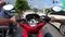 Torurist riding a red rental bike on the roads of Phuket