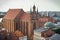 ToruÅ„, Poland - August 19, 2022: View from tower on church of Assumption of Blessed Virgin Mary and old or modern buildings in