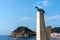 Tossa de Mar, Spain, August 2018. Bronze seagull and a view of the old fortress.