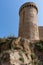 Tossa de Mar, Spain, August 2018. Corner tower of the old fortress on a steep cliff.