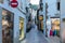 Tossa de Mar, Spain, August 2018. Lighted shop windows on the evening street of the old city.