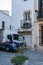 Tossa de Mar, Spain, August 2018. An old butcher shop in the center and a car for delivery.