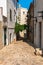 Tossa de Mar, Spain, August 2018. Old pavement made of rough stone on a narrow street of the old city.