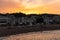 Tossa de Mar, Spain, August 2018. Orange sunset over the sandy beach in the city center.