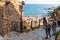 Tossa de Mar, Spain, August 2018. Vacationers on the stairs leading to the beach.