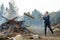 Tossing firewood in the fire. A man throws logs into the fire in nature.