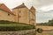 Tosterup castle with huge yellow buildings and a bridge over the moat