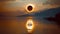 Total solar eclipse event over a lake with reflection.