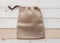 Tote bag with drawstring mockup of small eco sack made from jute hessian canvas or natural hemp burlap flat lay on white
