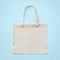 Tote bag mock up canvas white cotton fabric cloth for eco shoulder shopping sack mockup blank template isolated on pastel blue