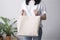 Tote bag mockup. Woman is holding tote bag canvas fabric for mockup. Lady bag with blank template