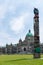 Totem pole with British Columbia Parliament in background - Victoria, Canada.