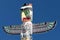 A totem wood pole in the blue cloudy background