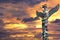 A totem wood pole in the gold cloudy background