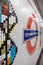 Tottenham Court Road Underground Station, London, UK showing mosaic tiles by Eduardo Paolozzi and the TFL Roundel in soft focus.