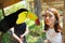 Toucan bird and a teenage girl at a zoo
