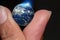 Touch Earth with finger,Elements of this image furnished by NASA