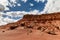 Touching the blue sky and the clouds carrying boulders of all sizes, Vermillion cliff range, Page, AZ, USA