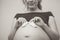 Touching photo of pregnancy moments young expectant mother with socks on her belly