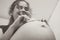 Touching photo of pregnancy moments young expectant mother with socks on her belly