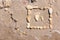 Touching picture of sea pebbles on  sandy beach. Image of a child`s and adult`s foot made of stones. Ebbles and sand in the sea.