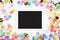 Touchpad with blank screen on colorful confetti background. Color party background with touchscreen pc